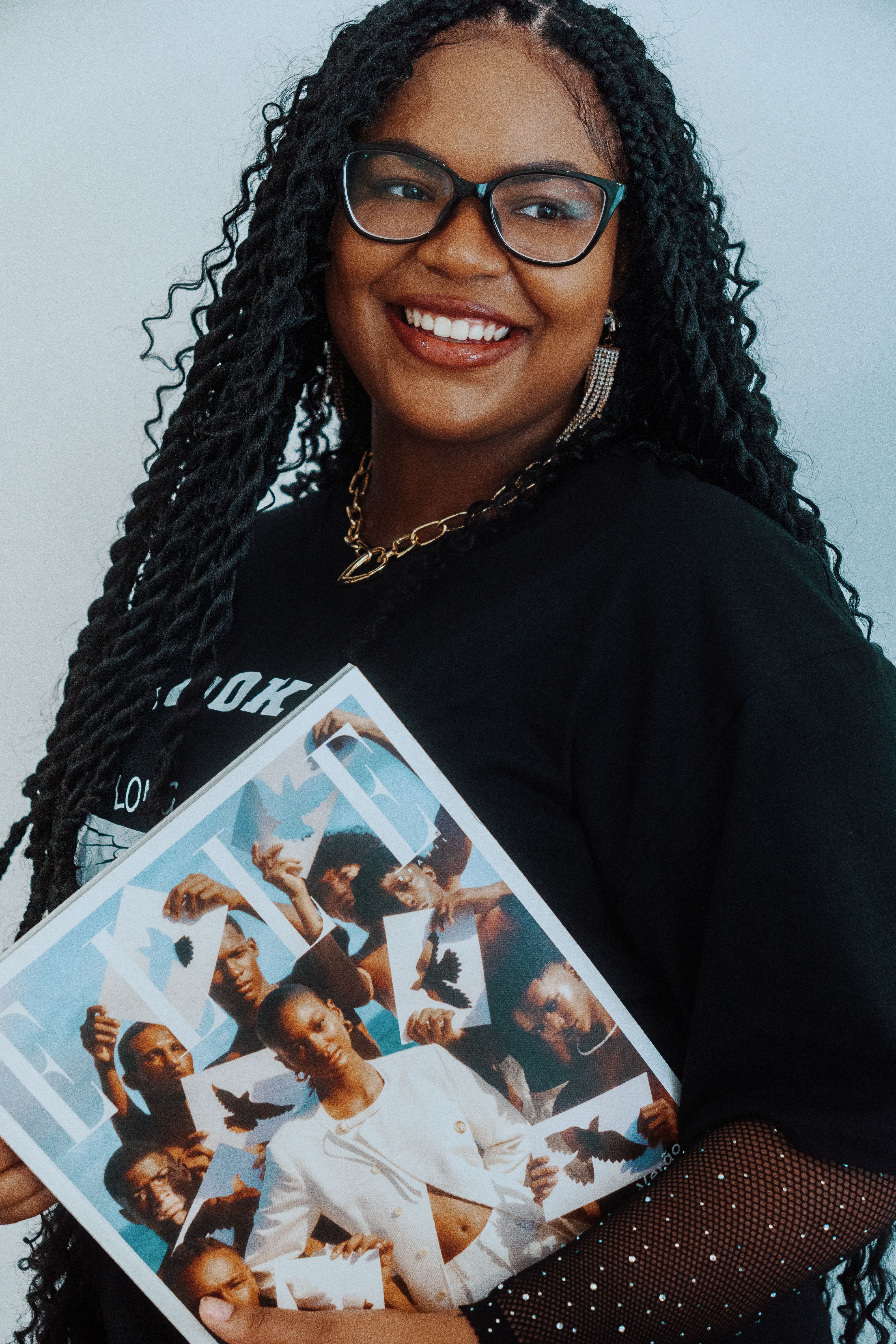 Happy woman holding a collage with diverse portraits, showcasing cultural diversity.