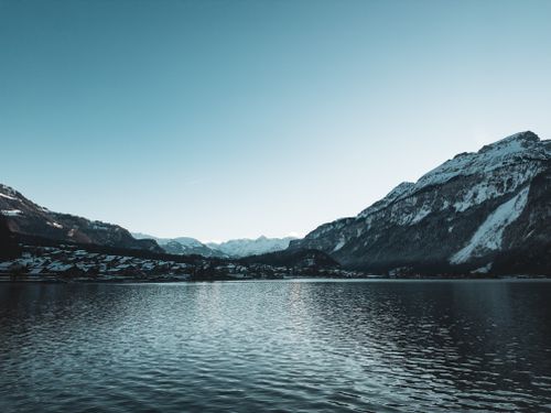 Free Peaceful winter scene of mountains and lake, capturing natural beauty and tranquility. Stock Photo