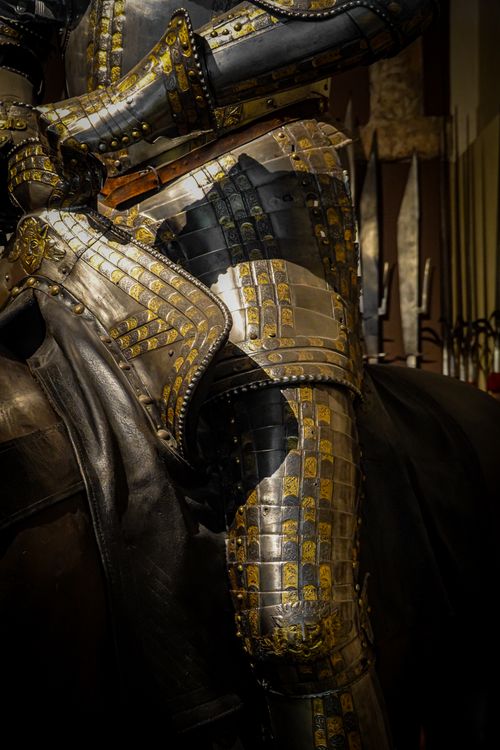 Free Close-up of detailed medieval steel armour with golden accents, showcasing intricate craftsmanship. Stock Photo