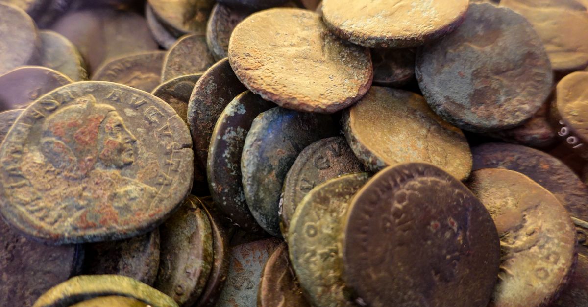 Rüyada Toprağın Altında Para Aramak - Rüya Tabiri ve Anlamı - Close-up of weathered ancient Roman coins displaying rich textures and patinas, symbolizing history and archaeology.