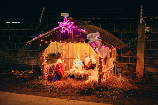 Vibrant outdoor nativity scene with glowing lights celebrating Christmas at night.