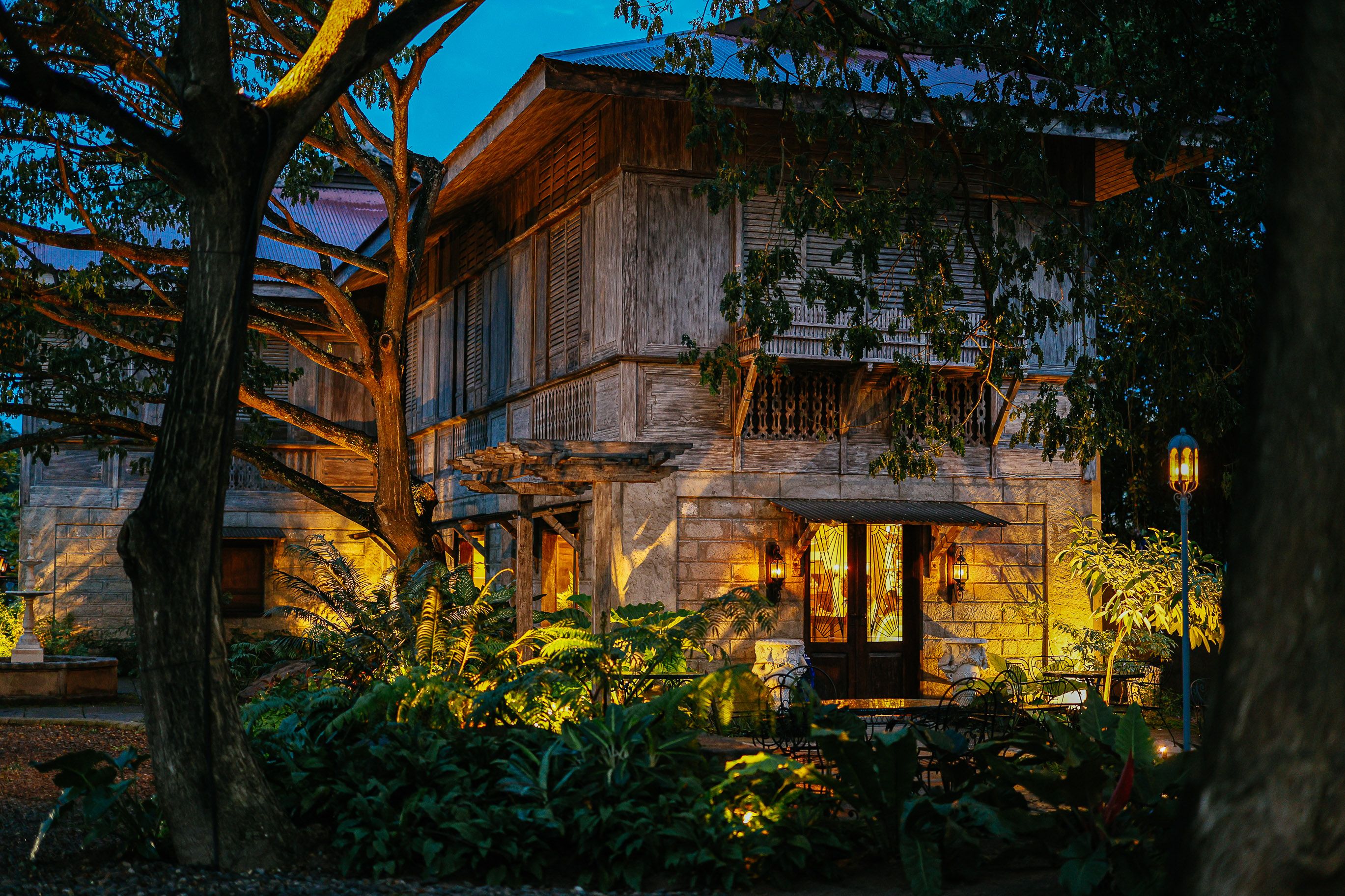 Charming Rustic House at Night with Lush Garden · Free Stock Photo