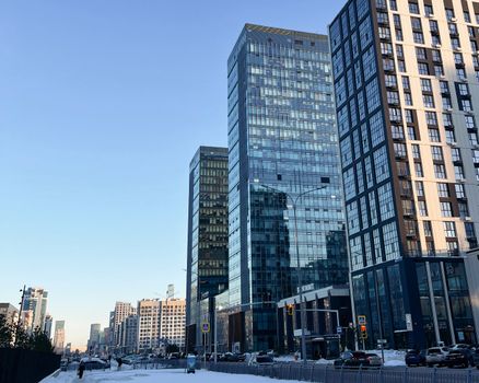 A vibrant cityscape of modern skyscrapers in Astana, Kazakhstan with a clear blue sky.