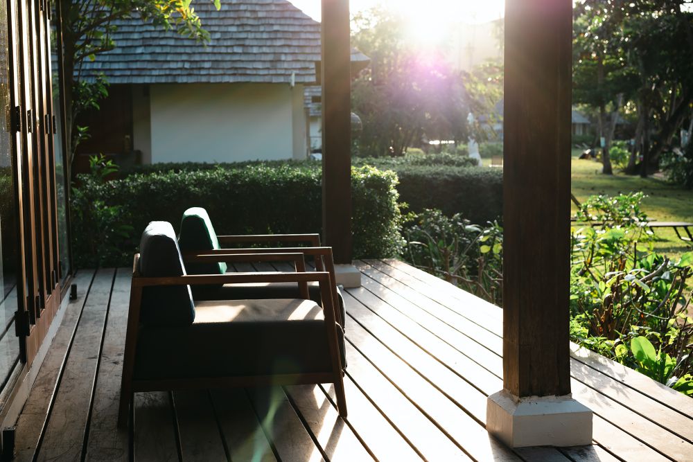 Wooden outdoor living area with beams, deck, and patio furniture