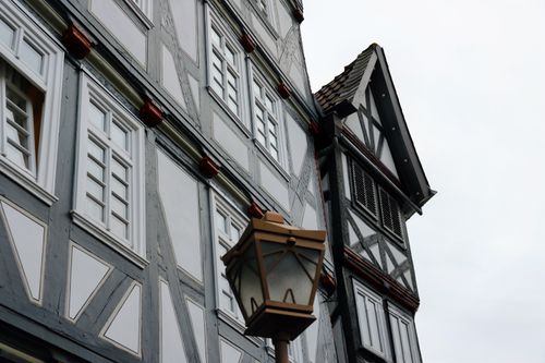 Free Detailed view of traditional Fachwerk buildings in Fritzlar, Germany, with a vintage lantern. Stock Photo