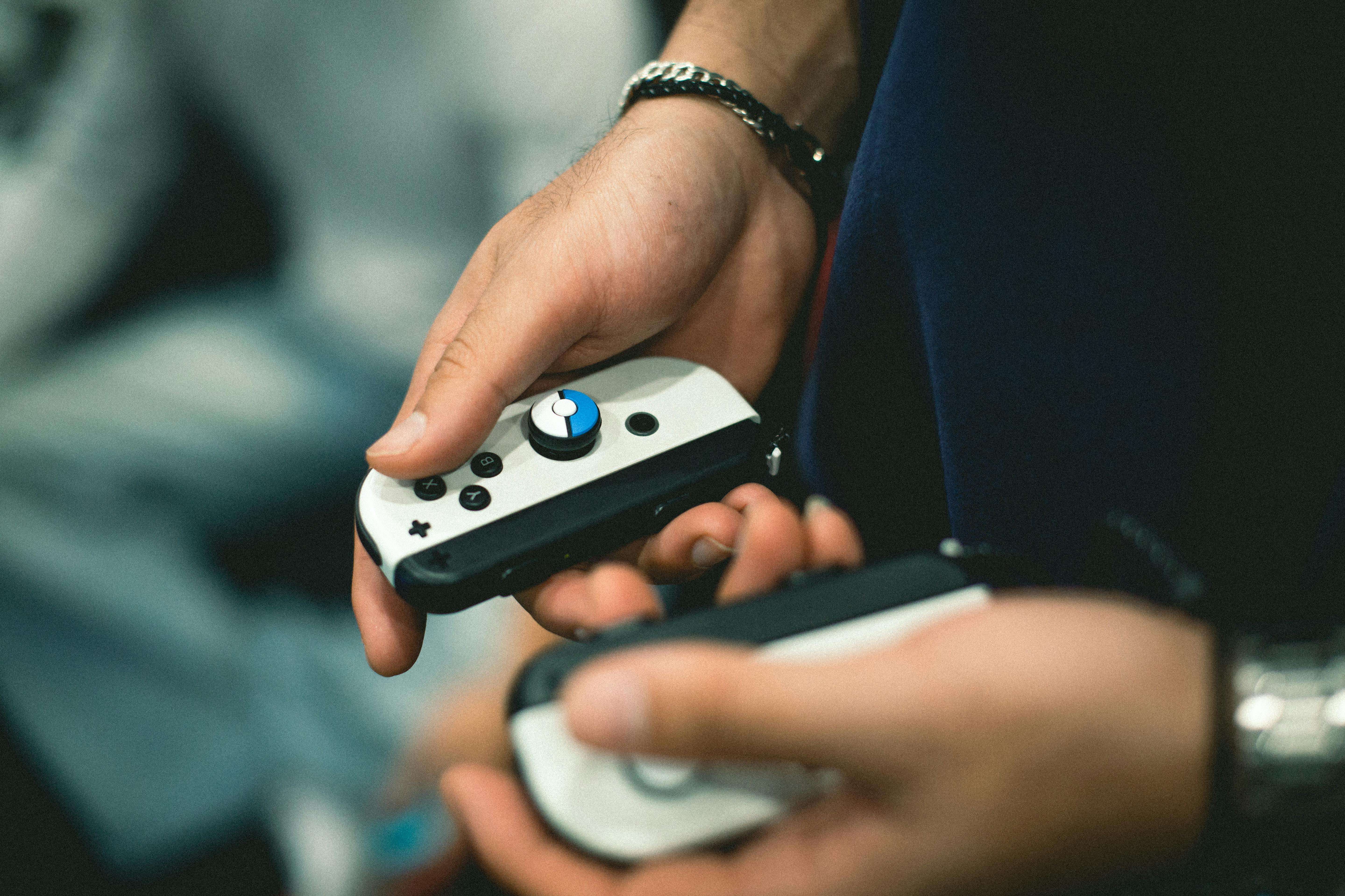 A detailed view of hands holding game controllers, perfect for gaming and technology themes.