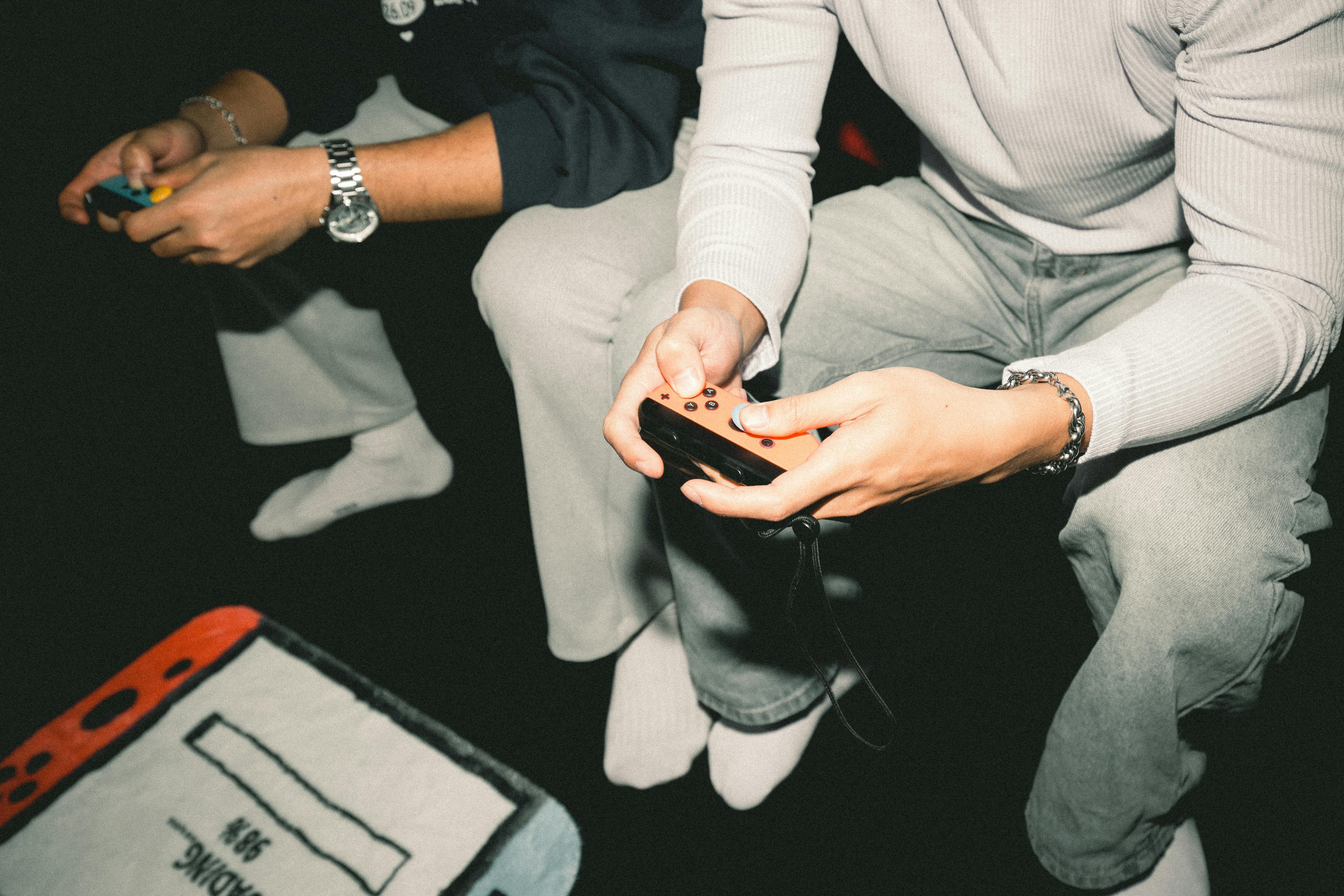 Two adults enjoying a video game session together, focused on controllers.