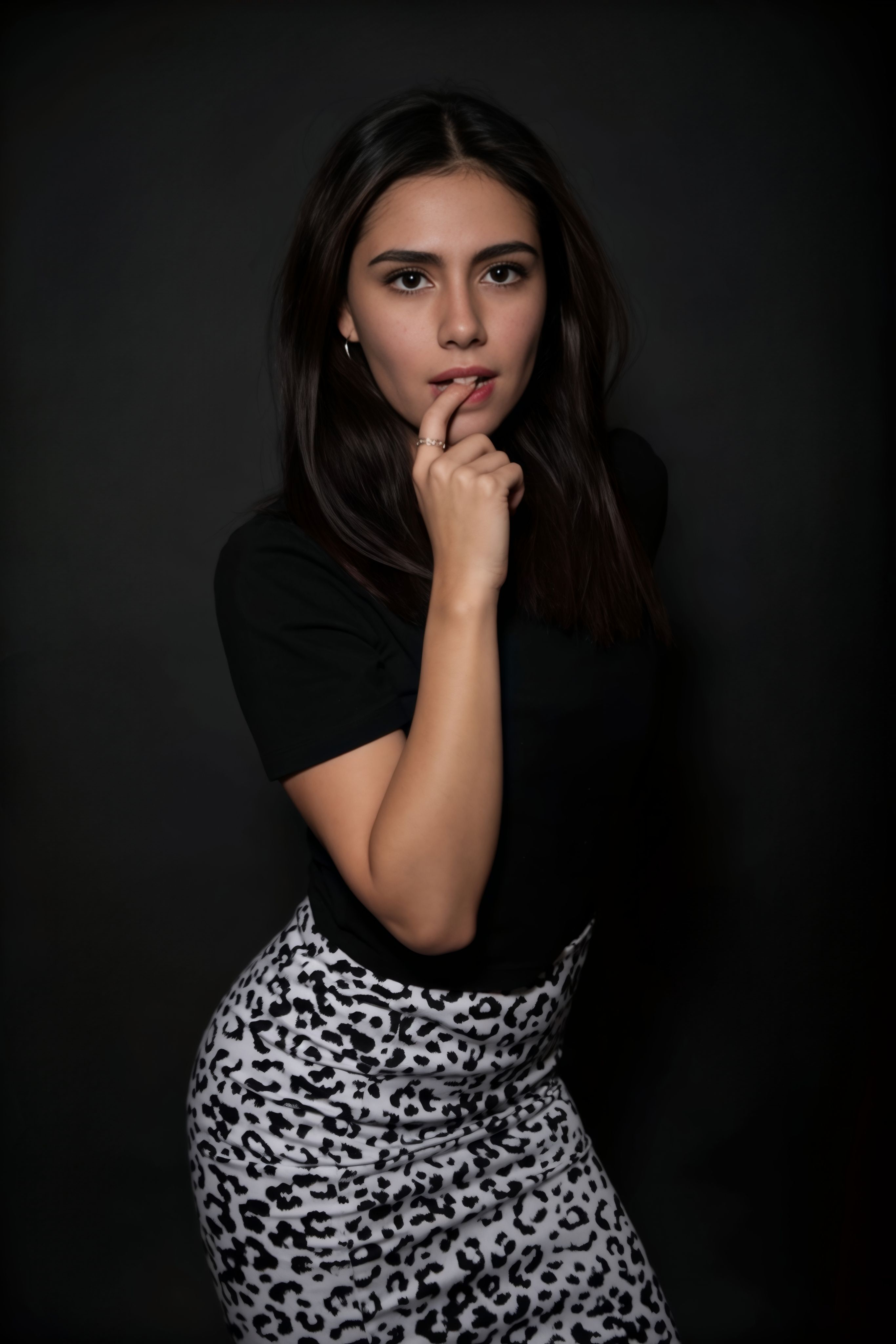 Elegant Woman in Black Top and Patterned Skirt · Free Stock Photo