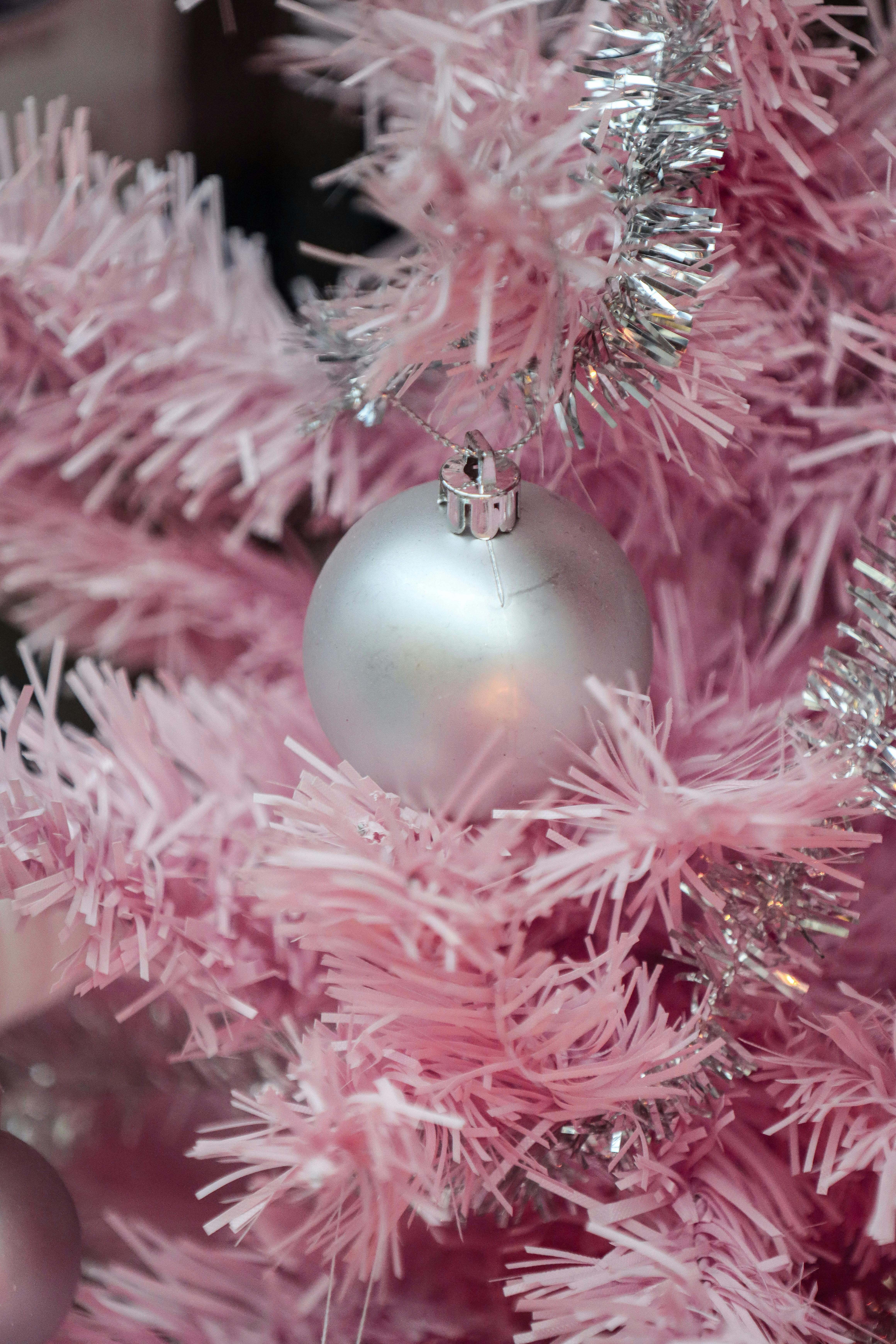 vibrant pink christmas tree with silver ornaments