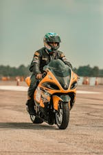 A Racer Riding His Motorcycle in the Race Track · Free Stock Photo