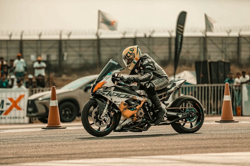 A Racer Riding His Motorcycle in the Race Track · Free Stock Photo