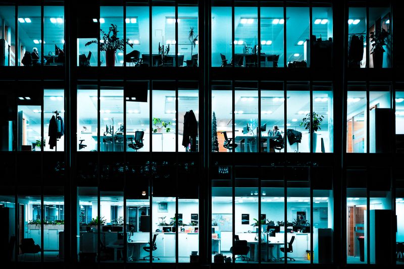 Modern corporate office building at night with illuminated windows