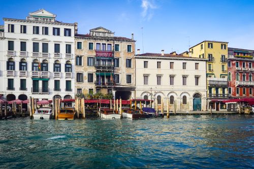 Free Charming Venetian canal view featuring classic architecture and colorful buildings. Stock Photo