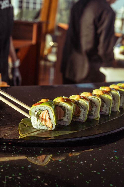 Free Tempting sushi rolls with avocado and salmon, perfect for a gourmet meal setting. Stock Photo