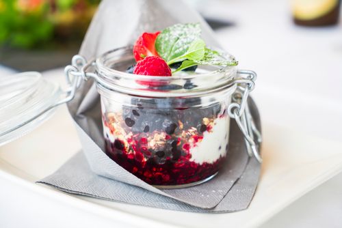 Free Homemade berry dessert with cream and mint in a glass jar, perfect for breakfast. Stock Photo