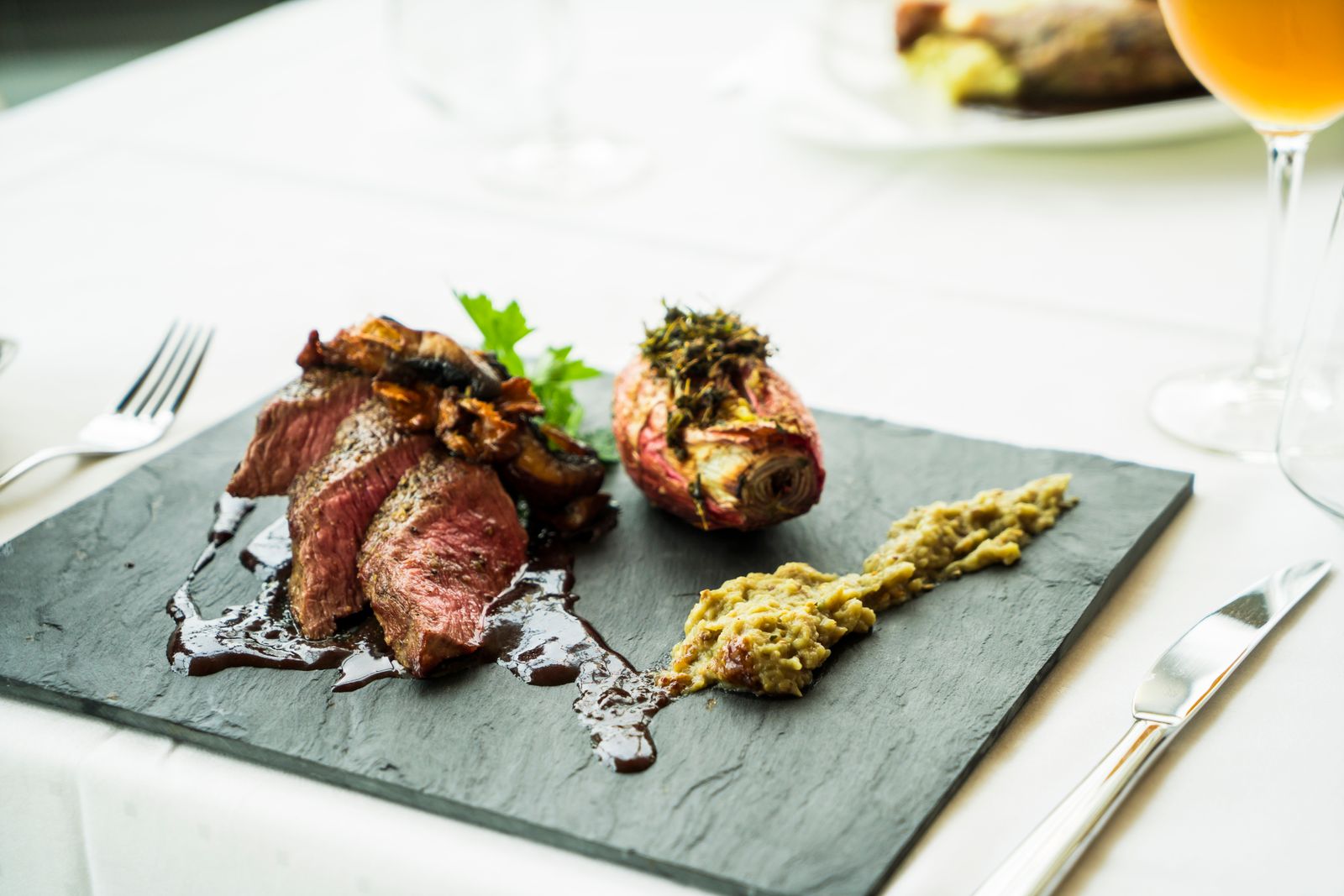 Grilled steak plated with herbs — photo by Terje Sollie on Pexels