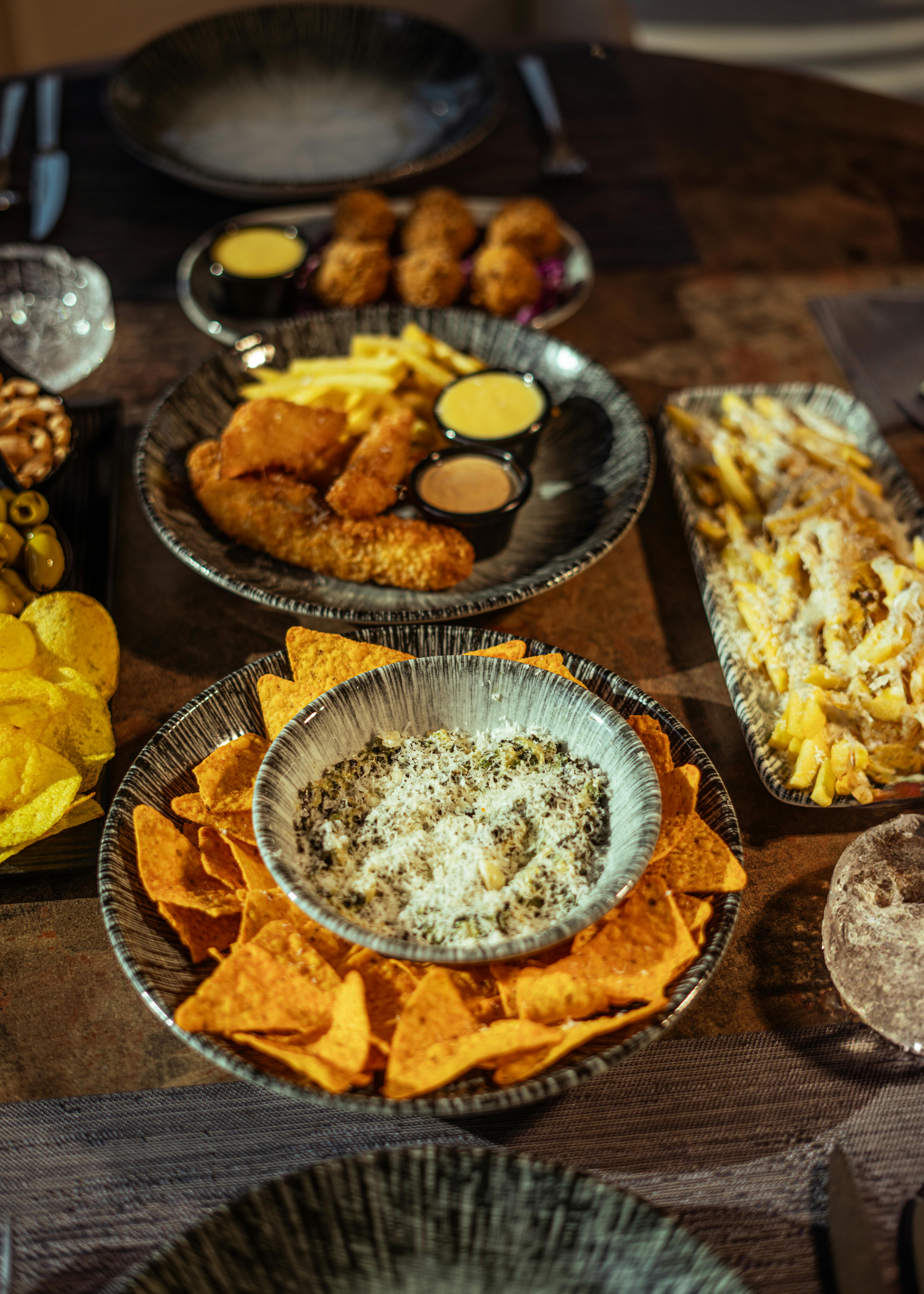 Assorted Snack Platter with Dips on Rustic Table · Free Stock Photo