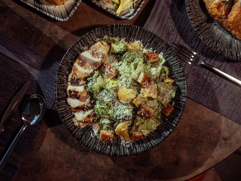 Appetizing Caesar salad with grilled chicken, croutons, and Parmesan cheese, perfect for a