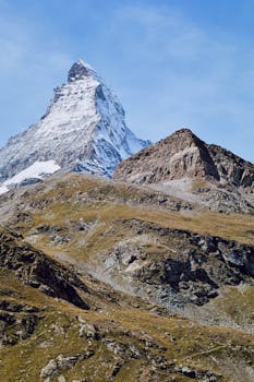 Capture of the majestic Matterhorn mountain peak during a clear day, showcasing its remarkable shape and snowy summit.