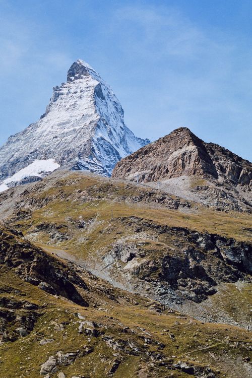 Free Capture of the majestic Matterhorn mountain peak during a clear day, showcasing its remarkable shape and snowy summit. Stock Photo