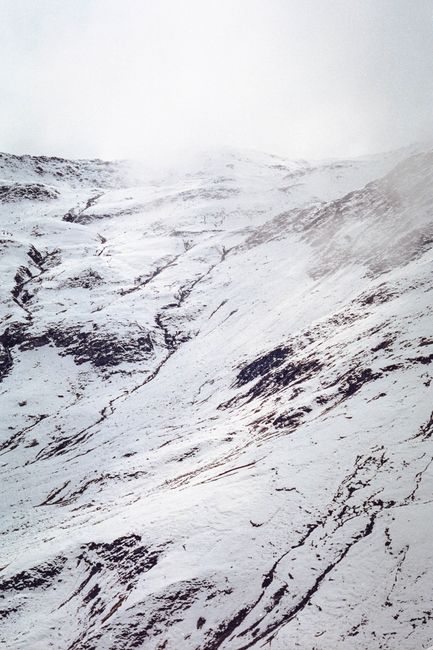 A breathtaking view of a snow-covered mountainside with dramatic textures and patterns in winter.