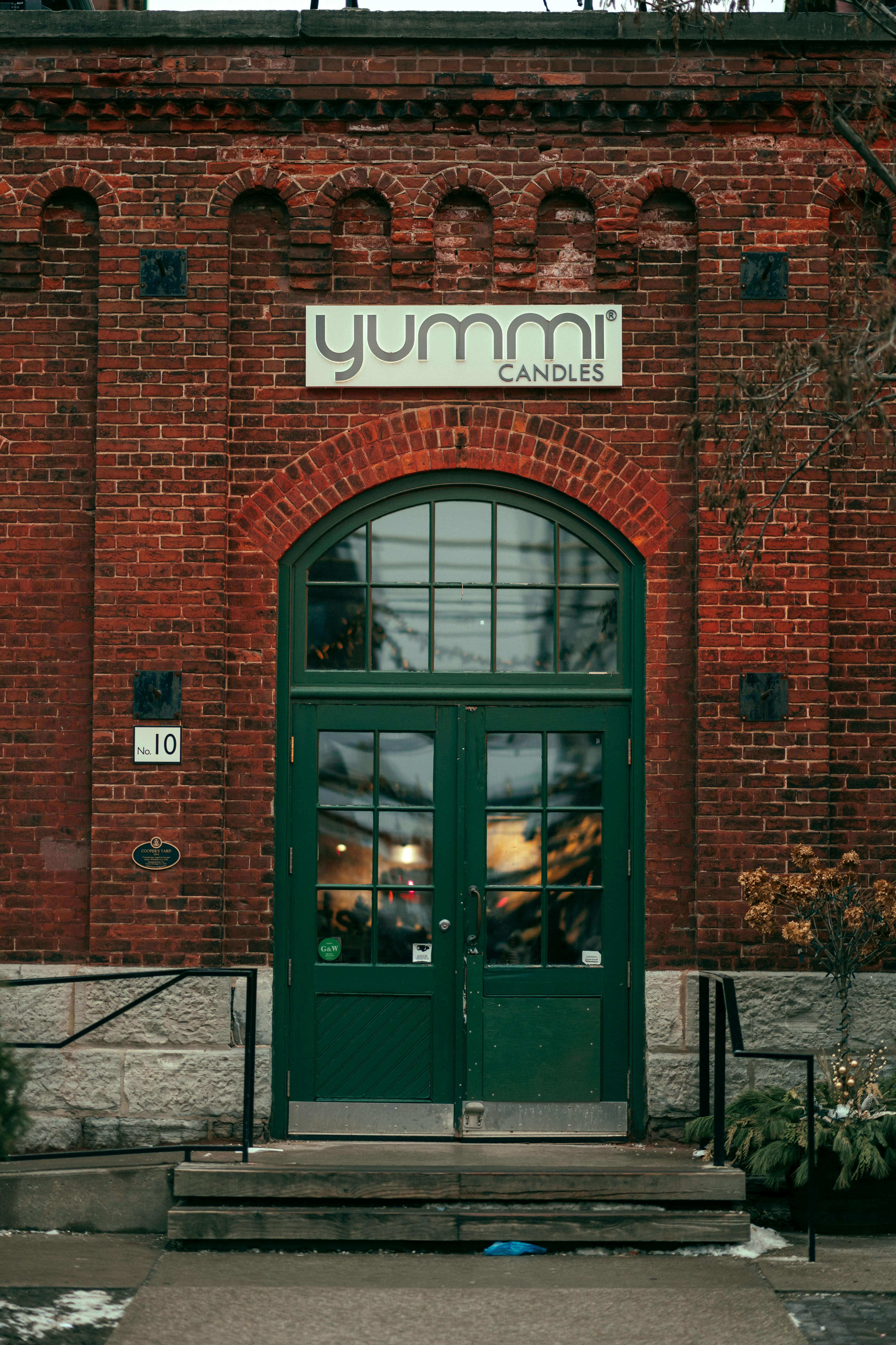 historic brick facade with green doors in toronto