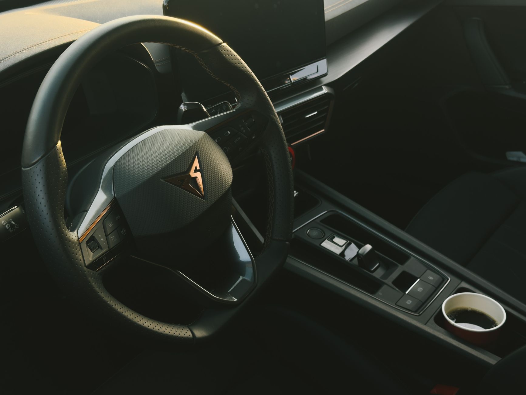 Sleek modern car interior featuring a stylish steering wheel and console.