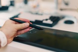Illustrator working at a drawing tablet — photo by Jakub Zerdzicki on Pexels