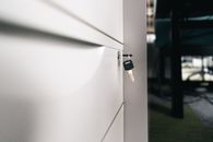 Close-up of a key in a locked office drawer for secure storage and privacy.