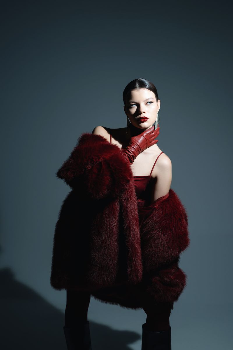 Woman wearing a faux fur stole over an elegant dress