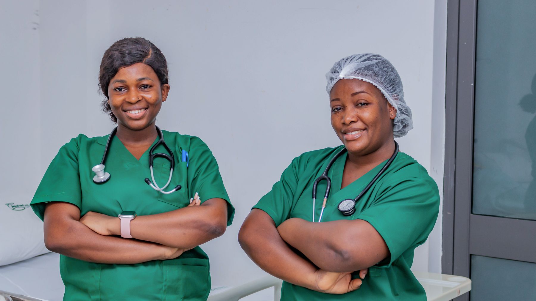 Two smiling nurses in a bright clinical setting representing a small practice team