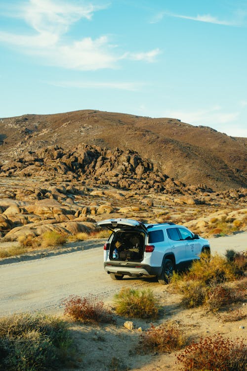 White Vehicle Parked on Dirt Road