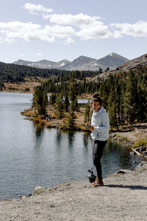 Man Standing Near Body Of Water