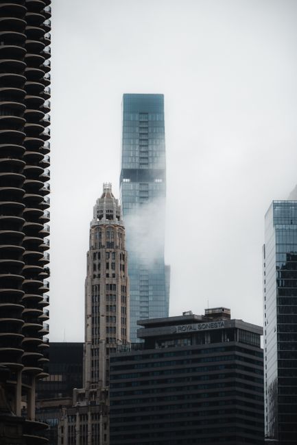 A moody view of Chicago's skyline enveloped in fog featuring prominent skyscrapers.