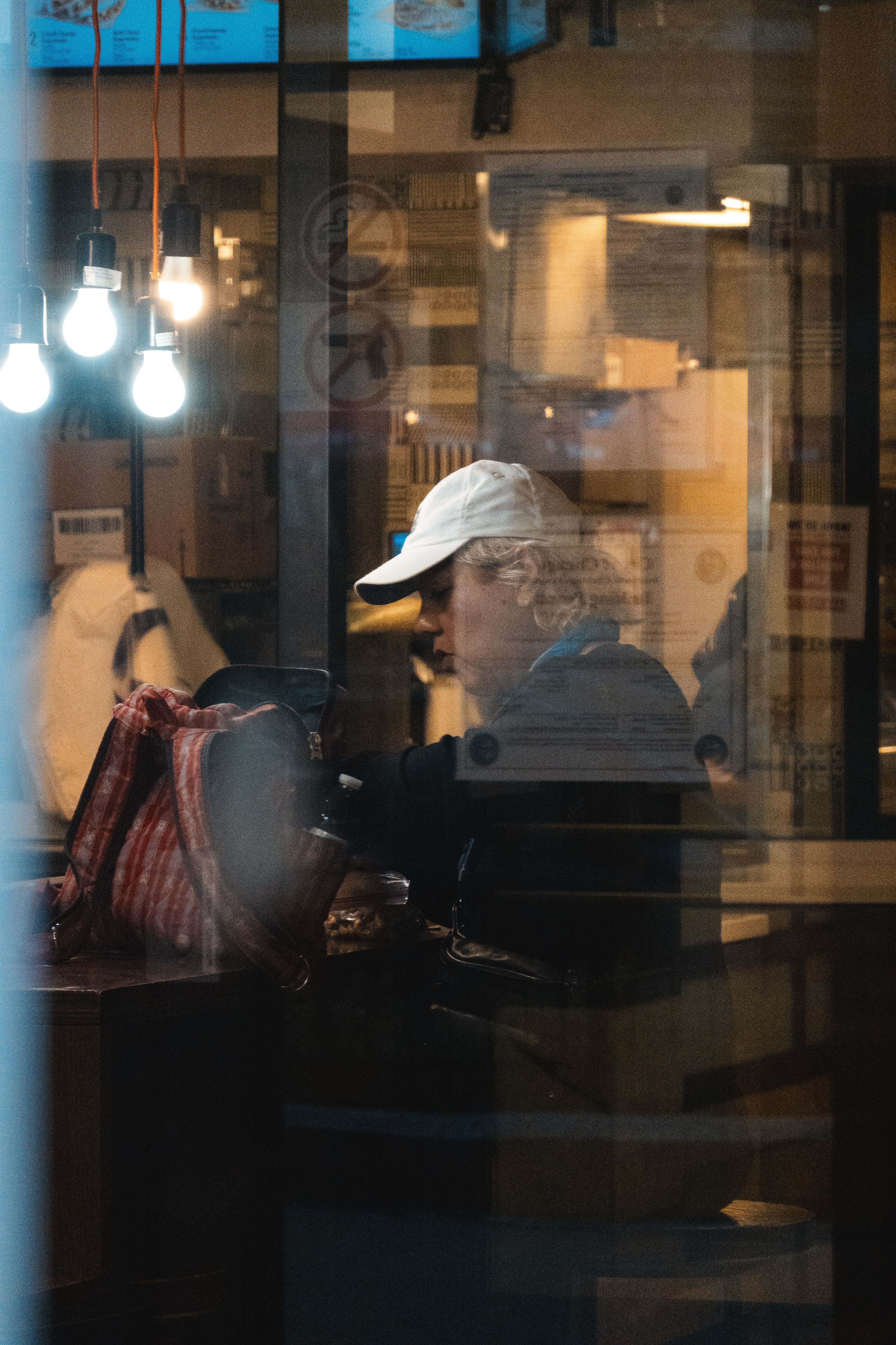 Man Observed Through Cafe Window at Night · Free Stock Photo