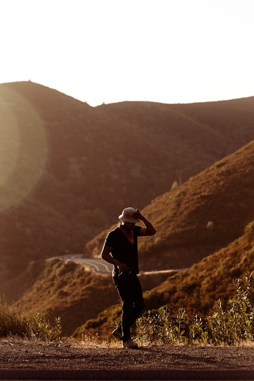 Man Walking Near Hill