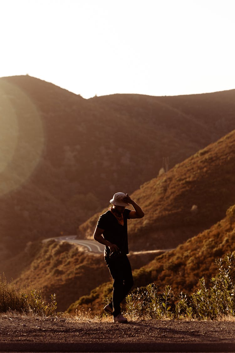 Man Walking Near Hill