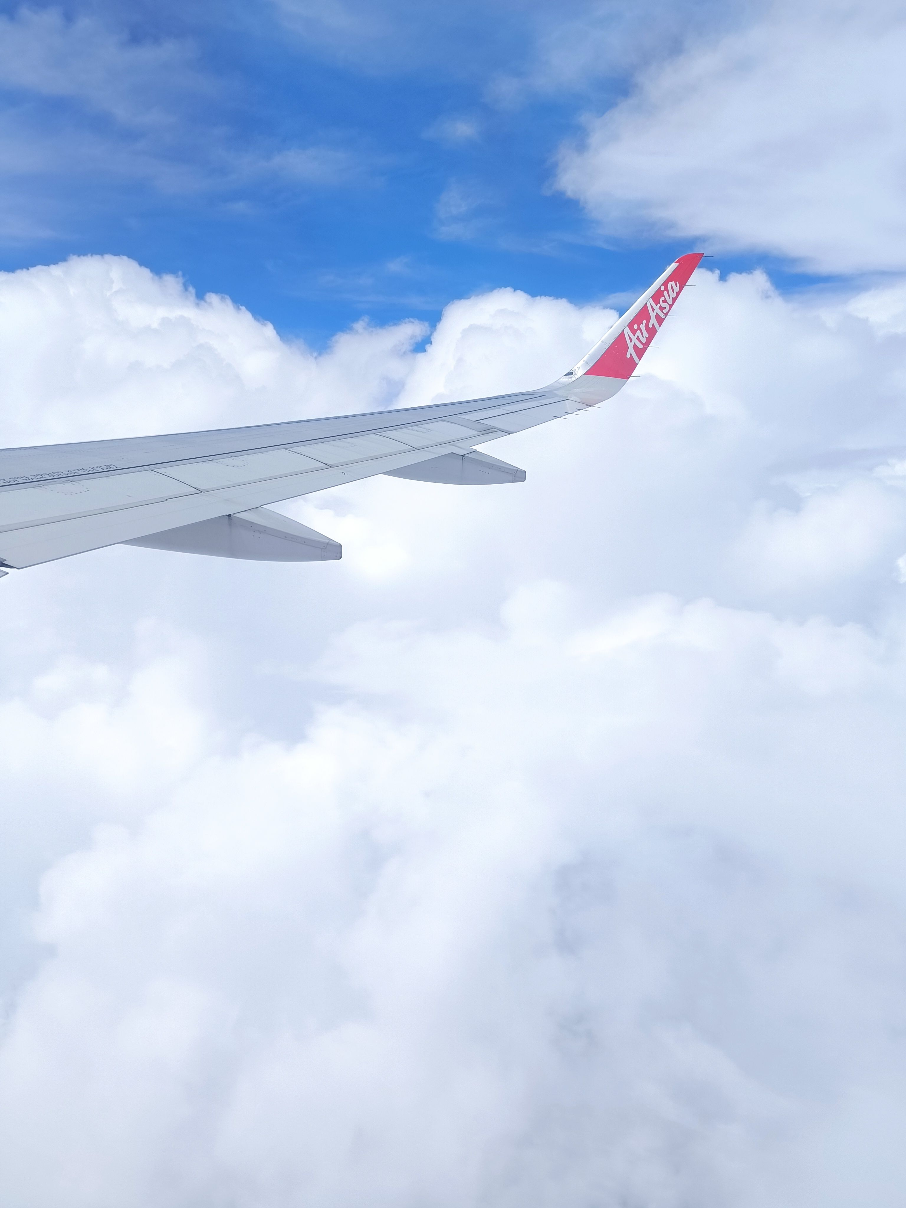 Airplane Wing in Flight with Blue Sky and Clouds · Free Stock Photo