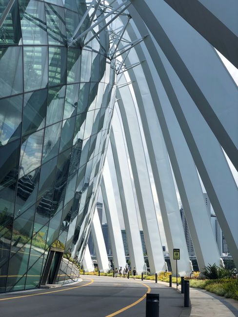 Architectural marvel featuring reflective glass panels and steel framework under daylight.