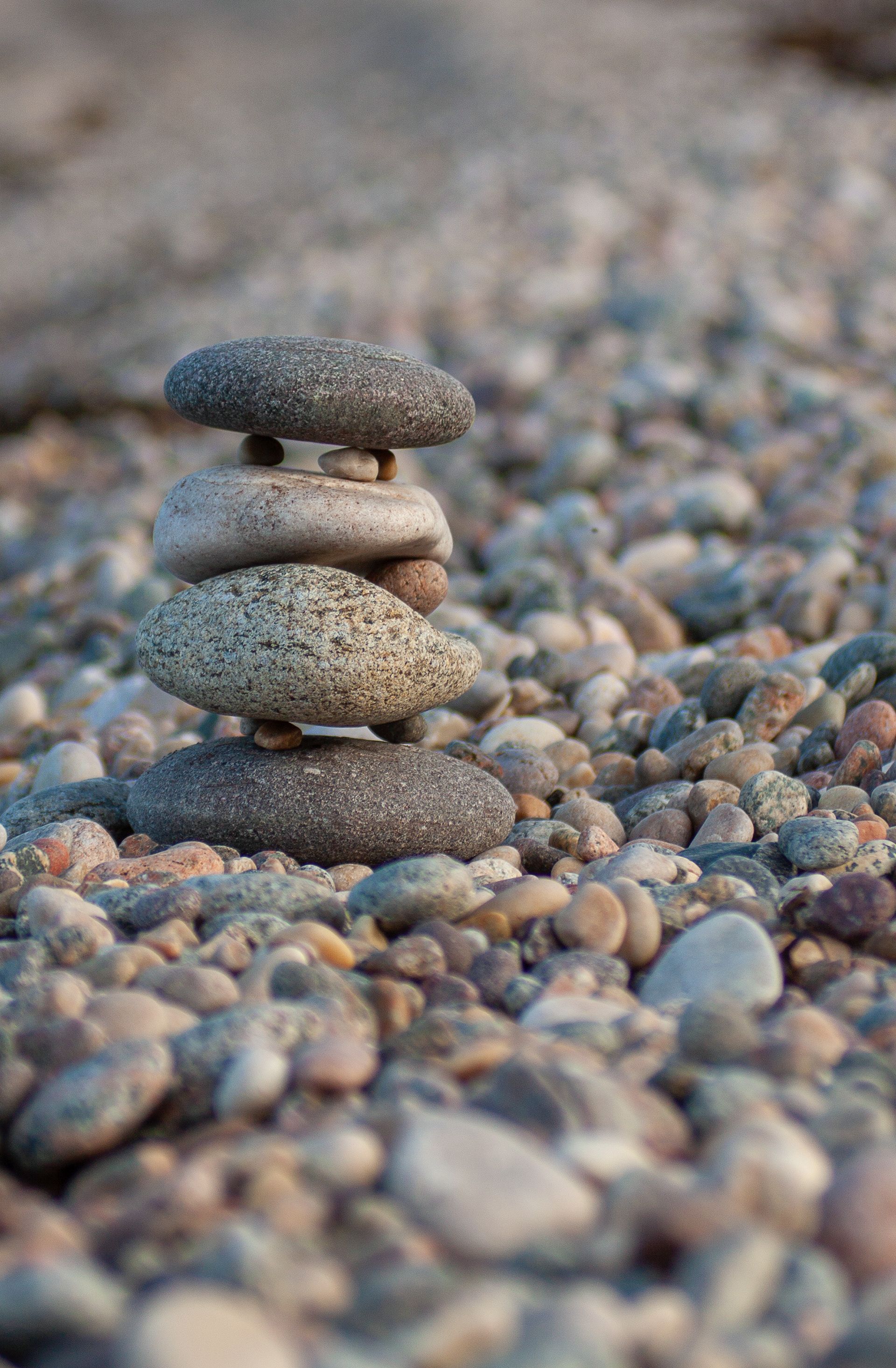 Serene Pebble Stack on a Rocky Beach · Free Stock Photo