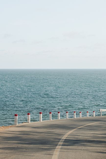 Peaceful view of a coastal road in Phan Thiet, Vietnam overlooking the calm sea.