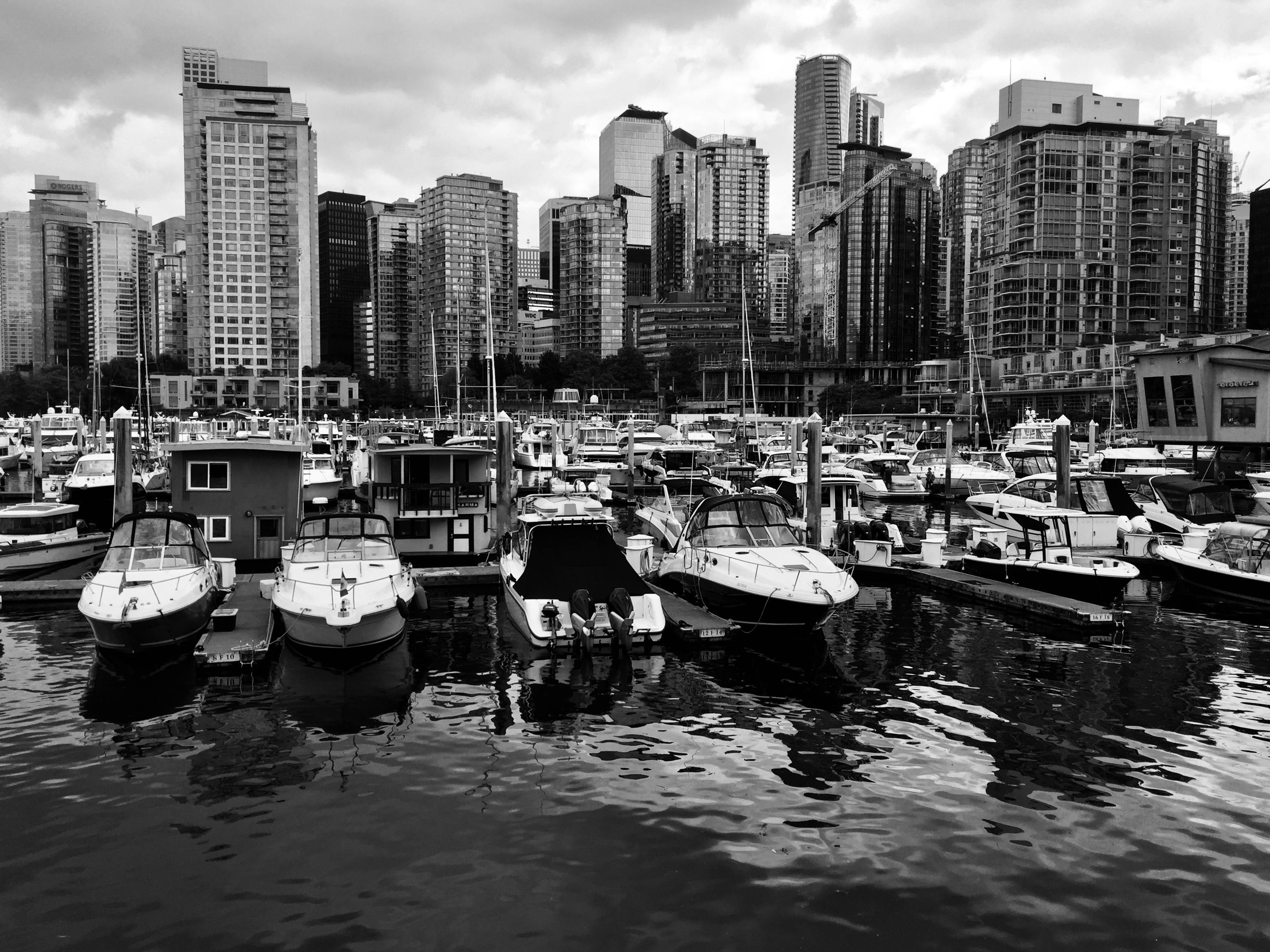 scenic view of boats docked with vancouver skyline