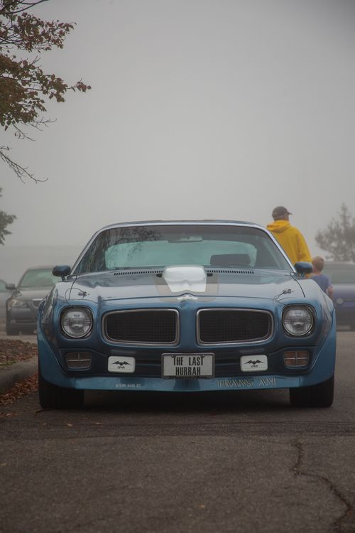 Free Front view of a classic blue Pontiac Trans Am on a foggy street. Stock Photo