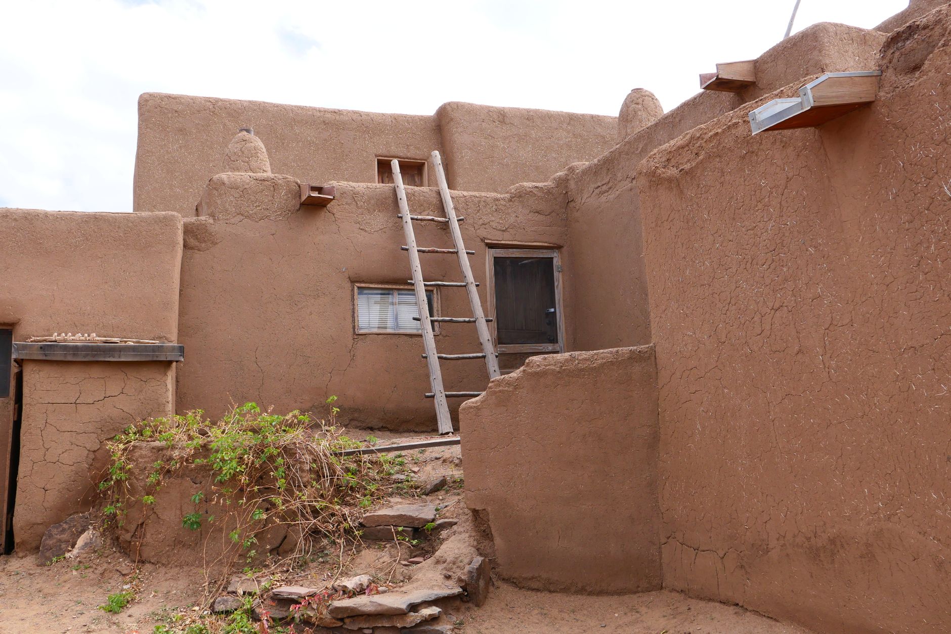 Traditional adobe architecture in Taos Pueblo, New Mexico showcasing rustic charm.