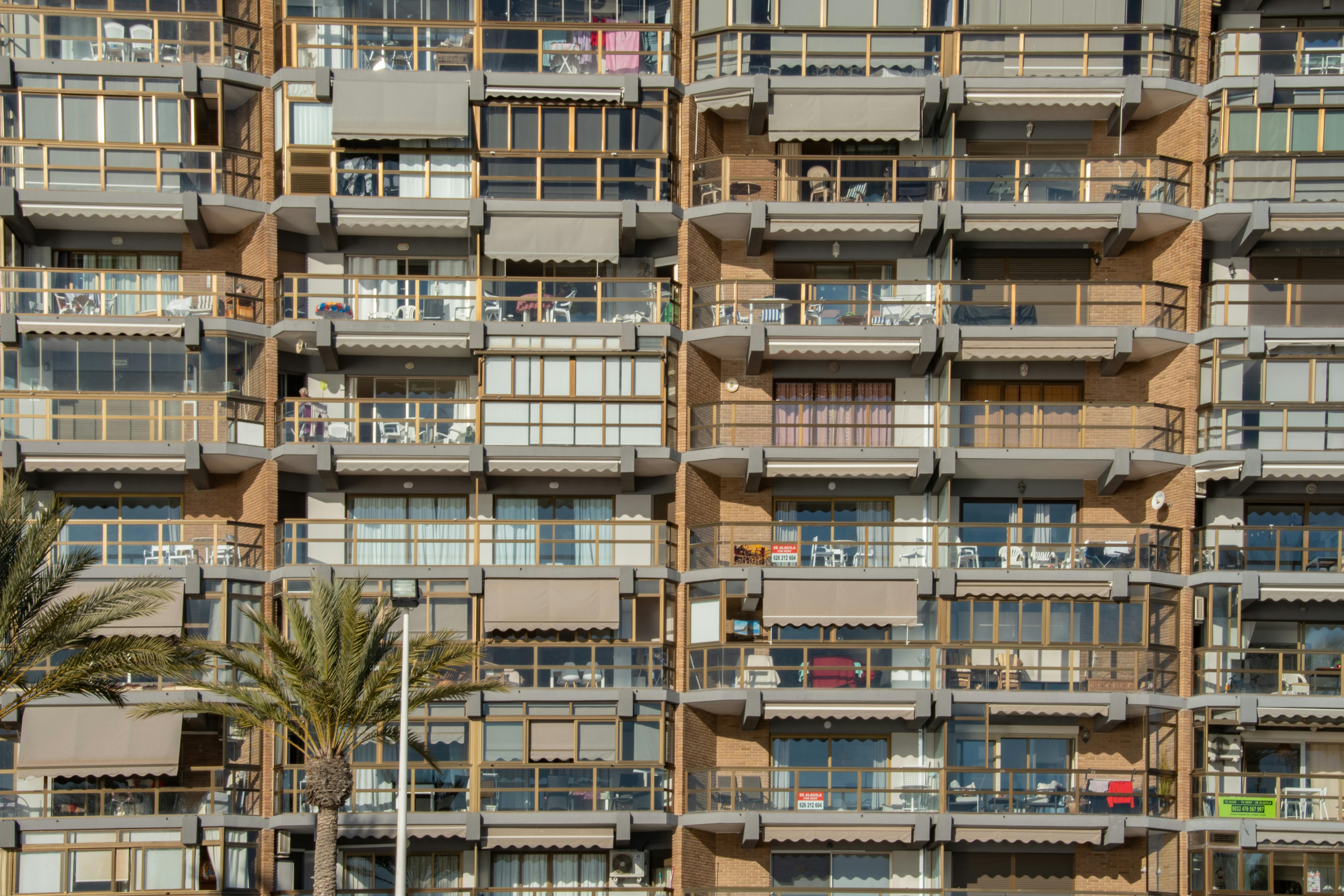 Detailed view of a modern apartment building facade with balconies in Calpe, Spain.