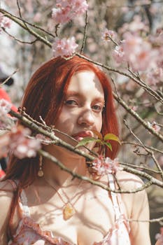 A woman enjoys the beauty of cherry blossoms outdoors in São Paulo, Brazil.