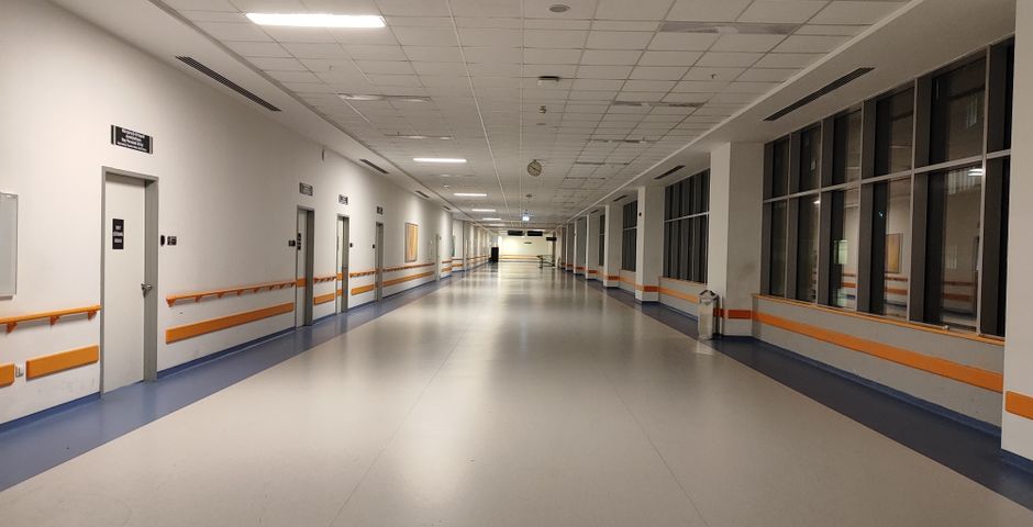 A clean modern hospital corridor — treatment is scheduled by zone around clinic hours