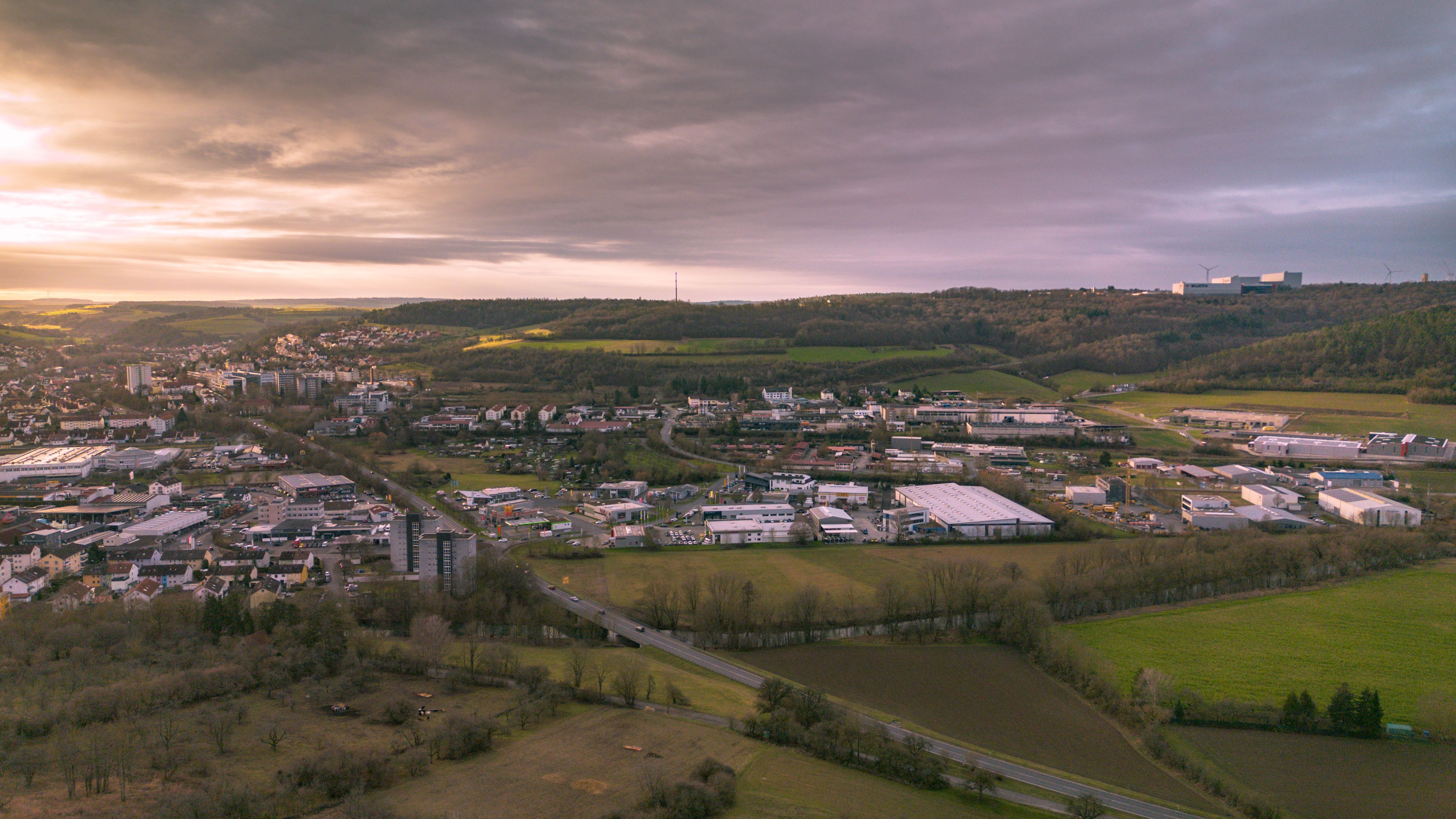 A stunning aerial view showcasing the German countryside with a town under a warm sunset.