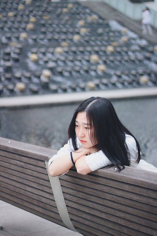 Woman Leaning on Bench