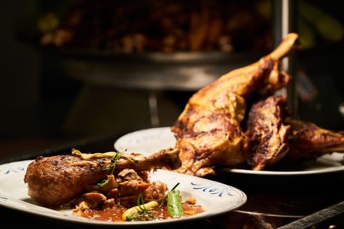 Free Delicious roast chicken legs garnished with herbs, perfect for a cozy dinner. Stock Photo